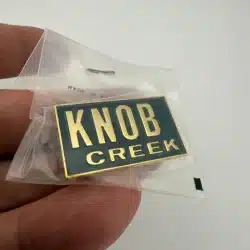 Knob Creek Bourbon Whiskey Promotional Pin - Gold Tone with Black Background